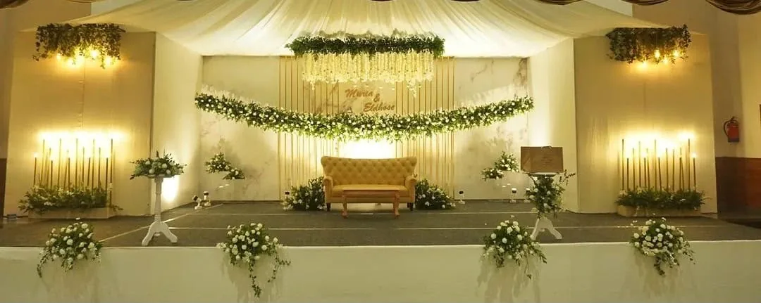 Golden wedding stage with white flowers